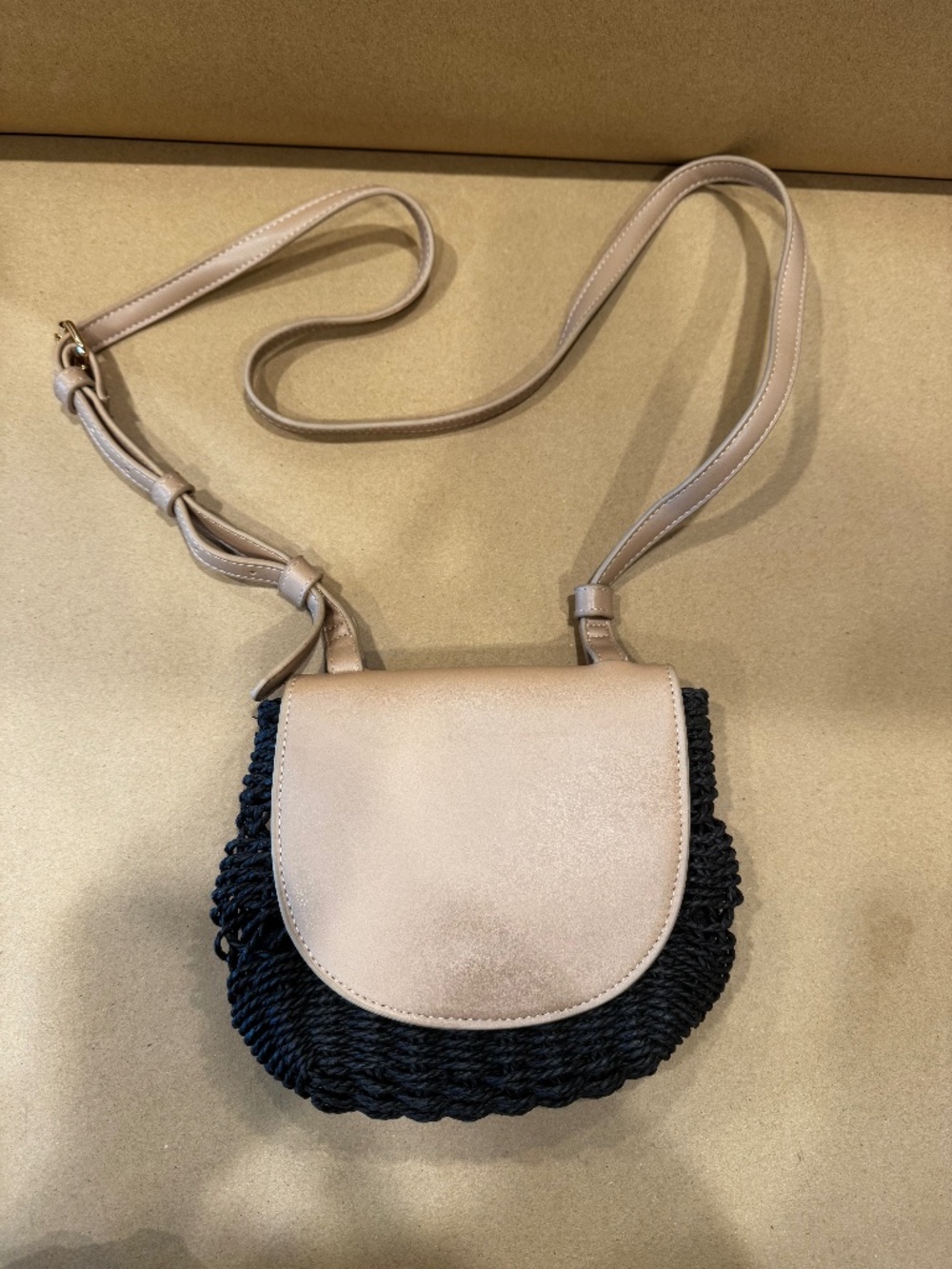 Tan and black woven cross shoulder bag